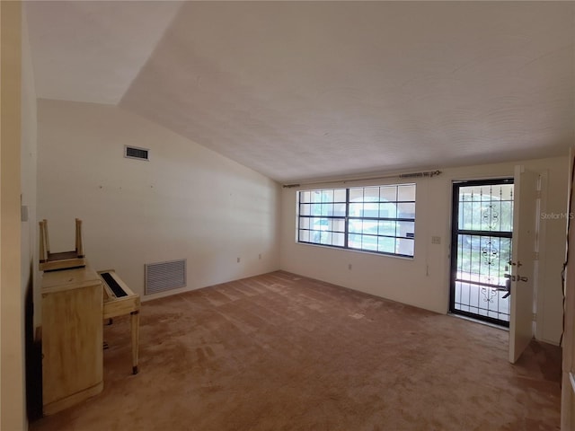 4420 Sawgrass Blvd, New Port Richey, FL 34653 - unfurnished living room with light carpet and vaulted ceiling