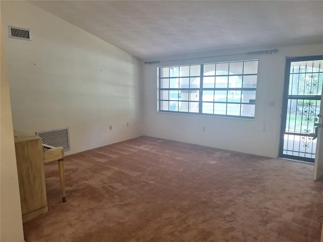 4420 Sawgrass Blvd, New Port Richey, FL 34653 - carpeted empty room featuring healthy amount of natural light and vaulted ceiling