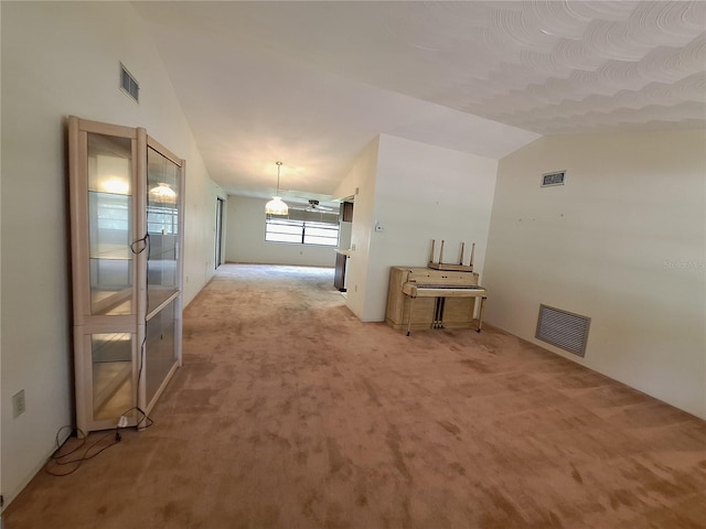 4420 Sawgrass Blvd, New Port Richey, FL 34653 - spare room with lofted ceiling and light colored carpet