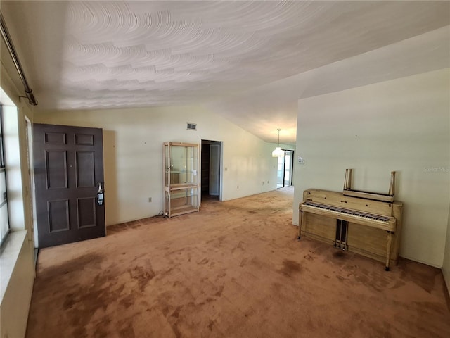 4420 Sawgrass Blvd, New Port Richey, FL 34653 - unfurnished living room with lofted ceiling and carpet flooring