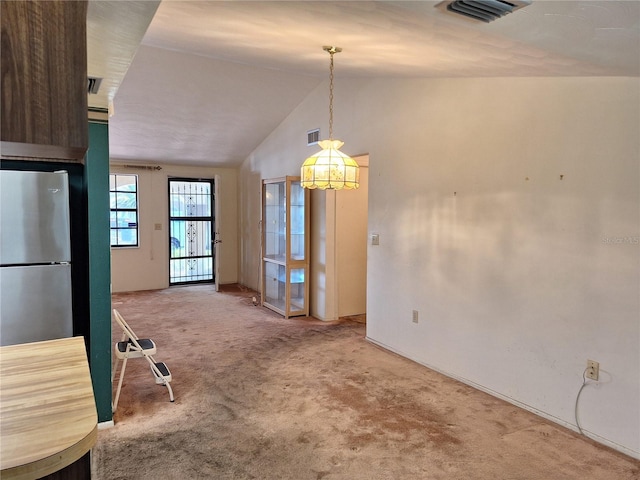 4420 Sawgrass Blvd, New Port Richey, FL 34653 - unfurnished dining area with carpet, vaulted ceiling, and a chandelier