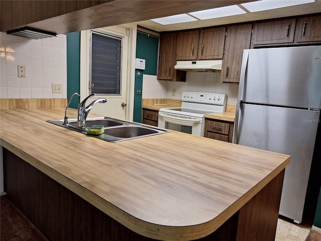 4420 Sawgrass Blvd, New Port Richey, FL 34653 - kitchen featuring freestanding refrigerator, white electric range, under cabinet range hood, wood counters, and backsplash
