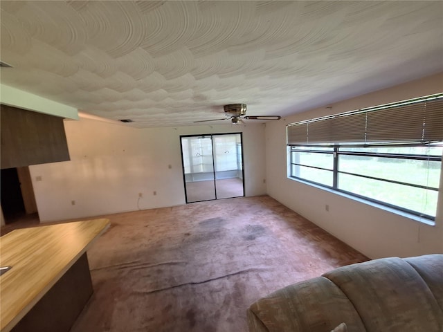 4420 Sawgrass Blvd, New Port Richey, FL 34653 - unfurnished living room with carpet flooring and a ceiling fan