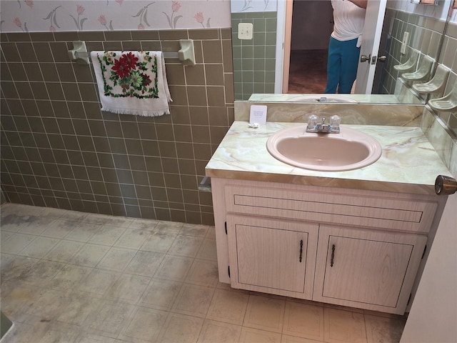 4420 Sawgrass Blvd, New Port Richey, FL 34653 - bathroom with vanity, tile walls, and wallpapered walls