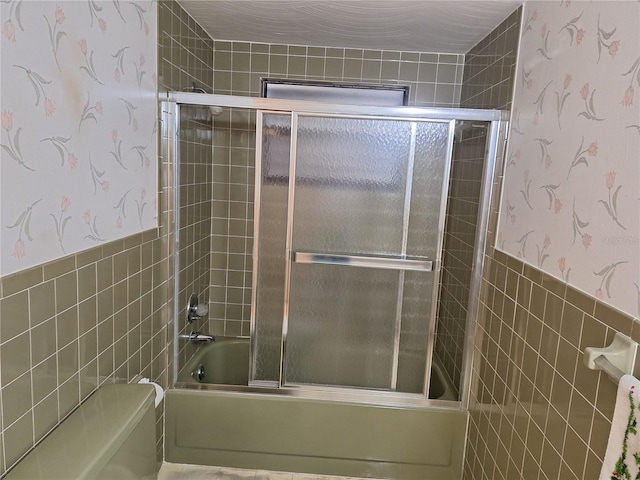 4420 Sawgrass Blvd, New Port Richey, FL 34653 - full bathroom with tile walls, wallpapered walls, combined bath / shower with glass door, and a wainscoted wall