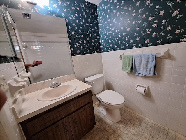 4420 Sawgrass Blvd, New Port Richey, FL 34653 - full bath with wallpapered walls, tile walls, vanity, and wainscoting