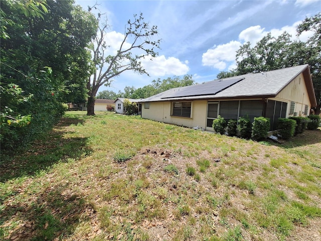 4420 Sawgrass Blvd, New Port Richey, FL 34653 - view of green lawn with a sunroom