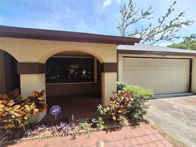 4420 Sawgrass Blvd, New Port Richey, FL 34653 - entrance to property featuring stucco siding, driveway, and an attached garage