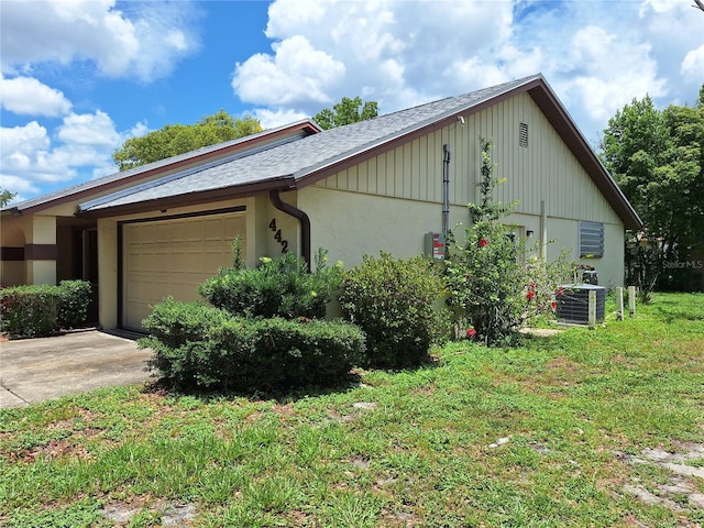 4420 Sawgrass Blvd, New Port Richey, FL 34653 - view of side of property featuring a garage, concrete driveway, and roof with shingles
