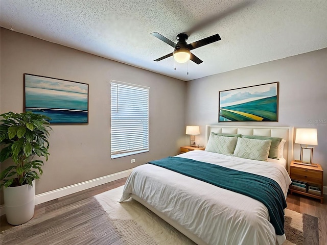 10124 Heathcliff St, Spring Hill, FL 34608 - bedroom featuring wood finished floors, a ceiling fan, and a textured ceiling