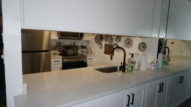5434 Chad Pl Unit 14, New Port Richey, FL 34652 - kitchen featuring stainless steel appliances, light countertops, and white cabinets