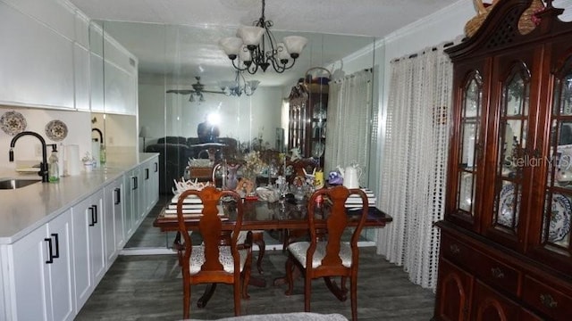 5434 Chad Pl Unit 14, New Port Richey, FL 34652 - dining area featuring a chandelier, dark wood-style floors, and crown molding