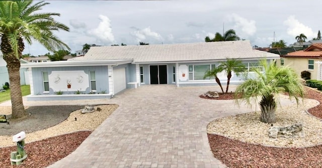 5339 Bowline Bnd, New Port Richey, FL 34652 - single story home featuring decorative driveway, a tile roof, a garage, and stucco siding