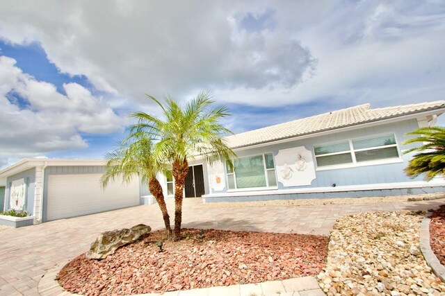 5339 Bowline Bnd, New Port Richey, FL 34652 - ranch-style home with an attached garage, decorative driveway, and a tiled roof