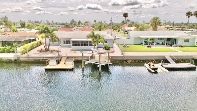 5339 Bowline Bnd, New Port Richey, FL 34652 - rear view of property featuring a water view, a residential view, a yard, and a sunroom