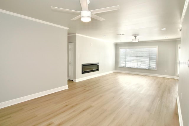 5339 Bowline Bnd, New Port Richey, FL 34652 - unfurnished living room featuring ornamental molding, light wood finished floors, a glass covered fireplace, and ceiling fan