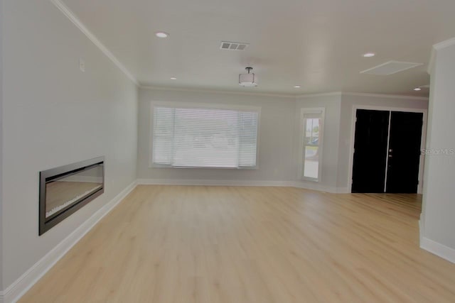 5339 Bowline Bnd, New Port Richey, FL 34652 - unfurnished living room with light wood-type flooring, a glass covered fireplace, ornamental molding, and recessed lighting