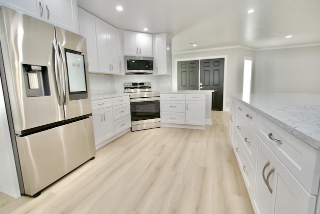 5339 Bowline Bnd, New Port Richey, FL 34652 - kitchen with stainless steel appliances, crown molding, white cabinets, light wood-style floors, and recessed lighting
