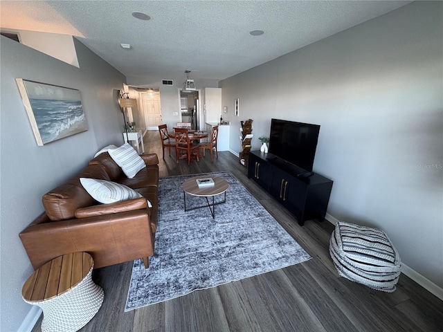 5555 Gulf Blvd Unit 315, St Pete Beach, FL 33706 - living room featuring dark wood-style flooring and a textured ceiling