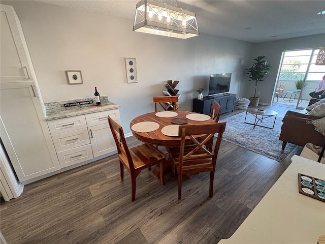 5555 Gulf Blvd Unit 315, St Pete Beach, FL 33706 - dining room featuring dark wood-type flooring and baseboards
