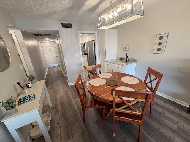 5555 Gulf Blvd Unit 315, St Pete Beach, FL 33706 - dining area with dark wood finished floors and a textured ceiling