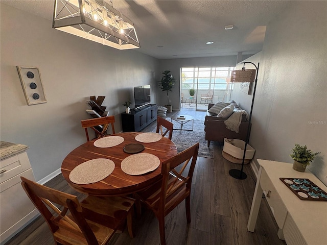 5555 Gulf Blvd Unit 315, St Pete Beach, FL 33706 - dining area featuring dark wood-type flooring and a textured ceiling