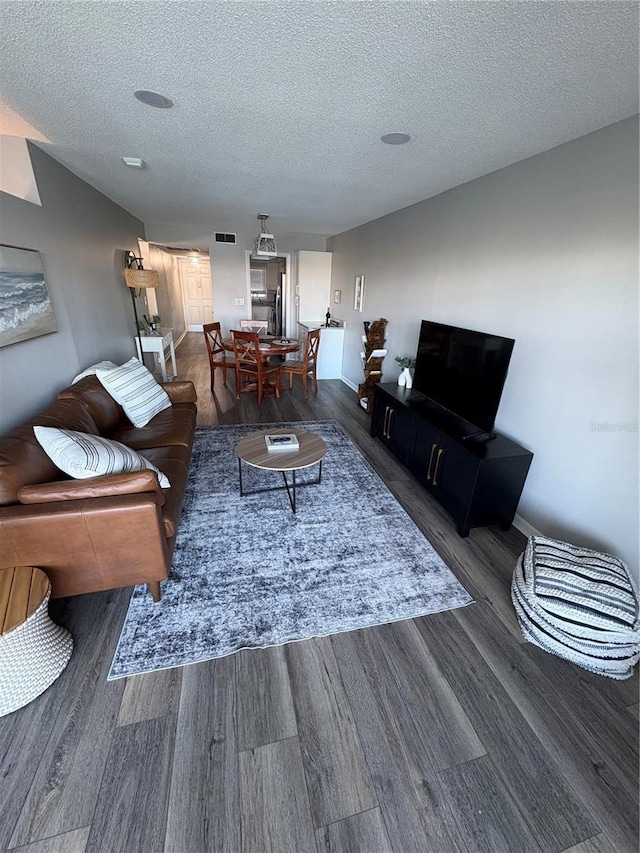 5555 Gulf Blvd Unit 315, St Pete Beach, FL 33706 - living room with wood finished floors and a textured ceiling