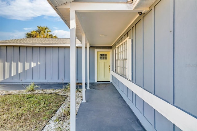 15950 Adobe Dr, Hudson, FL 34667 - property entrance featuring board and batten siding and roof with shingles