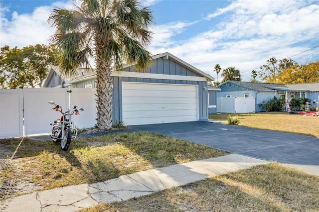 15950 Adobe Dr, Hudson, FL 34667 - ranch-style house featuring concrete driveway, board and batten siding, and an attached garage