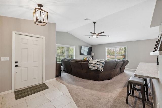 11034 Flock Ave, Weeki Wachee, FL 34613 - carpeted living area with healthy amount of natural light, lofted ceiling, a ceiling fan, tile patterned flooring, and a chandelier