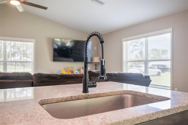 11034 Flock Ave, Weeki Wachee, FL 34613 - kitchen view of a ceiling fan and light stone counters