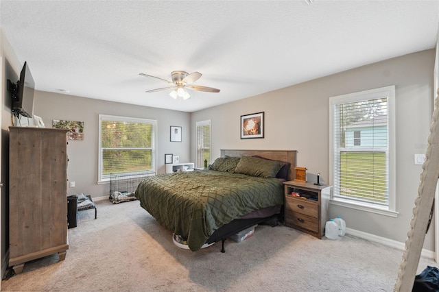 11034 Flock Ave, Weeki Wachee, FL 34613 - bedroom with light carpet and a ceiling fan