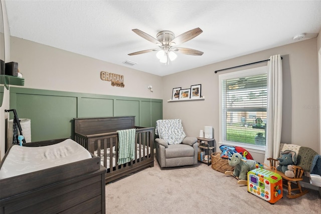 11034 Flock Ave, Weeki Wachee, FL 34613 - carpeted bedroom featuring ceiling fan and a crib