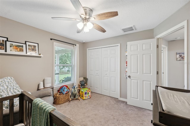 11034 Flock Ave, Weeki Wachee, FL 34613 - bedroom with light carpet, a closet, and a ceiling fan