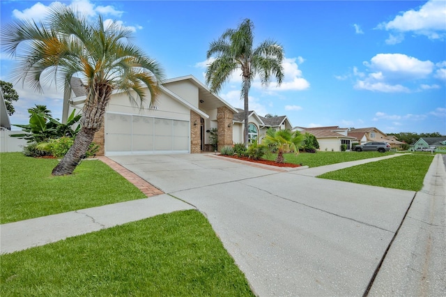 view of front facade featuring driveway, a front lawn, a garage, and stucco siding