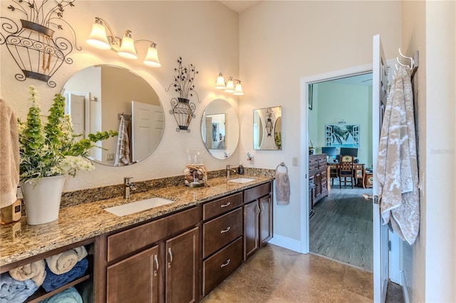 bathroom featuring double vanity and connected bathroom