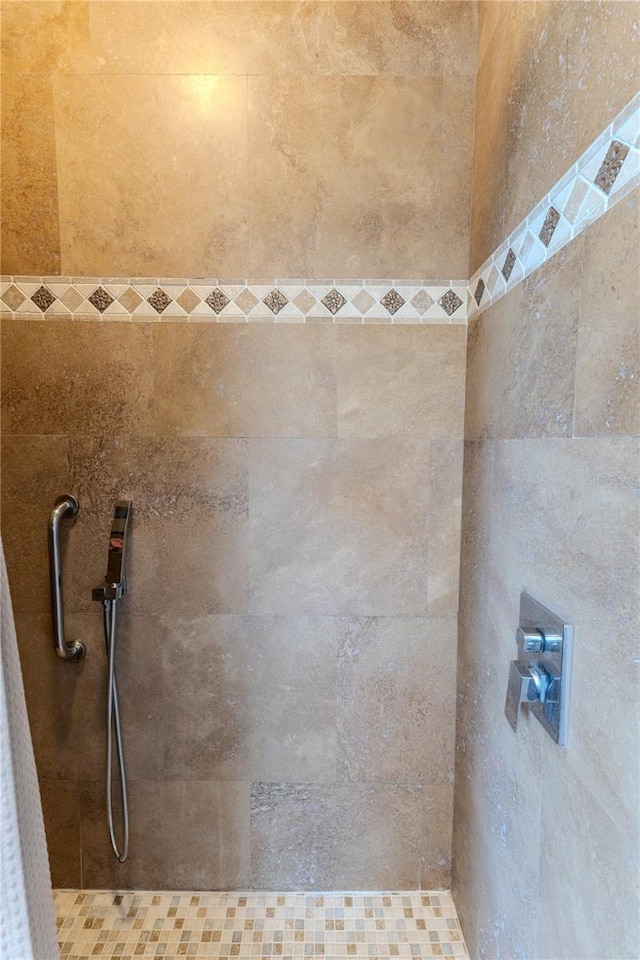 bathroom with tiled shower