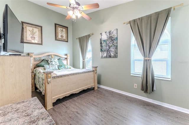 bedroom featuring wood finished floors and a ceiling fan