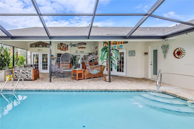 outdoor pool with french doors, a patio, and a lanai