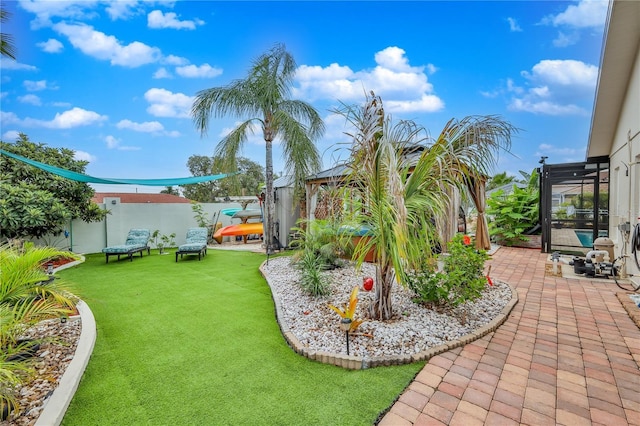 fenced backyard with a gazebo and a patio