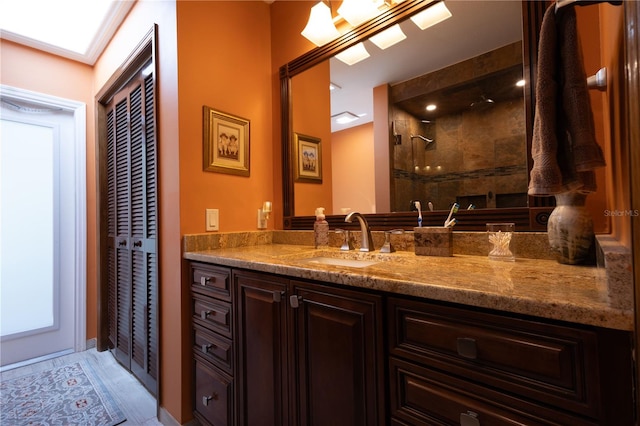 7550 Jomel Dr, Weeki Wachee, FL 34607 - bathroom with vanity, a tile shower, and a closet