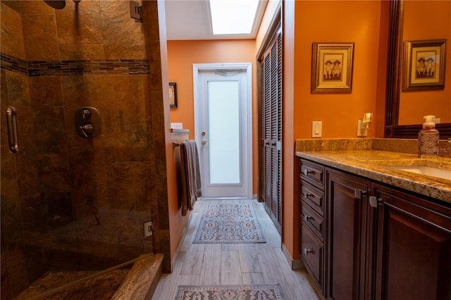 7550 Jomel Dr, Weeki Wachee, FL 34607 - bathroom with a shower stall, vanity, and wood finished floors