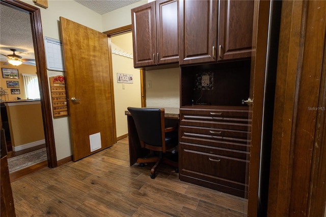 7550 Jomel Dr, Weeki Wachee, FL 34607 - office space with a textured ceiling, dark wood-style floors, and a ceiling fan