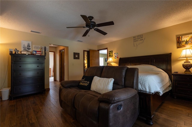 7550 Jomel Dr, Weeki Wachee, FL 34607 - bedroom with dark wood-style flooring, a textured ceiling, and ceiling fan