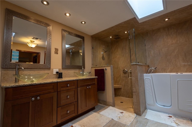 7550 Jomel Dr, Weeki Wachee, FL 34607 - full bathroom with a tile shower, a garden tub, double vanity, recessed lighting, and decorative backsplash