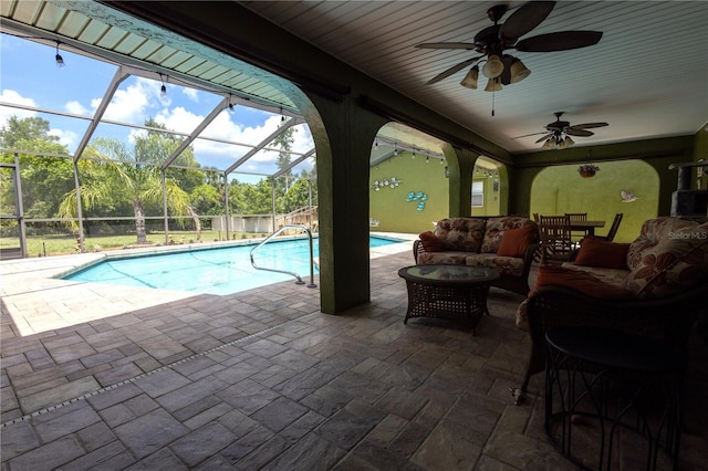 7550 Jomel Dr, Weeki Wachee, FL 34607 - outdoor pool featuring a patio, glass enclosure, an outdoor hangout area, and ceiling fan