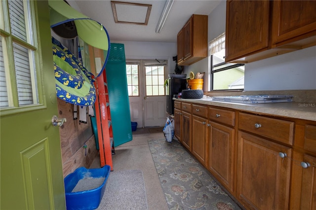 7550 Jomel Dr, Weeki Wachee, FL 34607 - kitchen featuring brown cabinets and light countertops
