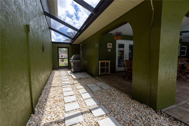 7550 Jomel Dr, Weeki Wachee, FL 34607 - view of yard featuring a patio area, glass enclosure, and french doors