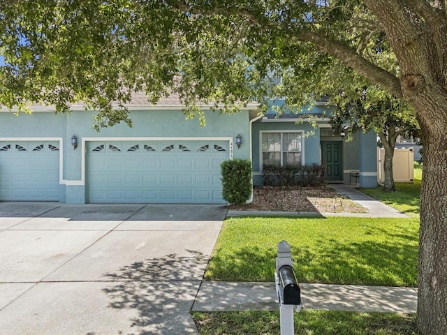 4481 Birchfield Loop, Spring Hill, FL 34609 - obstructed view of property with stucco siding, concrete driveway, a front yard, and a garage