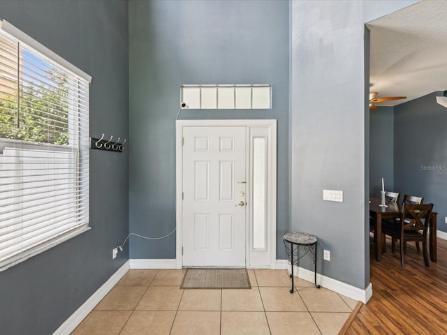 4481 Birchfield Loop, Spring Hill, FL 34609 - entrance foyer with tile patterned floors, a ceiling fan, and a high ceiling